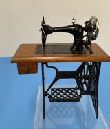 Sewing machine with treadle