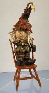 Fall Scarecrow Standing on Orange Chair