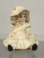 (image for) Vintage Doll Figurine in porcelain holding a doll