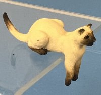 (image for) Metal Siamese Cat sits with her paws hanging down