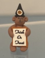 (image for) Brown Bear Wearing Witch Hat Holding "Trick or Treat" Sign