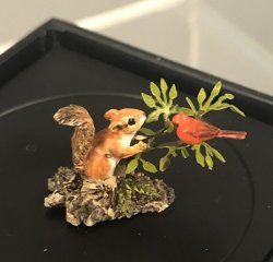 Tiny Squirrel with red bird