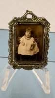 (image for) Silver frame with a black and white photo of a sitting child