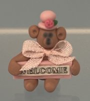 (image for) Brown Bear in Pink Hat Holding "Welcome' sign