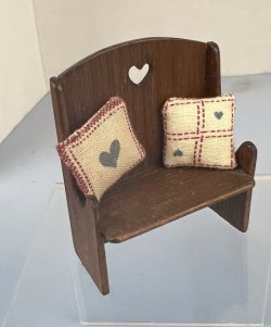 Settee with heart cut out and two pillows with hearts