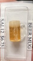 Beer Mug with a head overflowing down the side