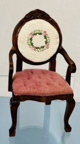 Pink cushion and cross stitched back on mahogany chair (image for) Pink cushion and cross stitched back on mahogany chair